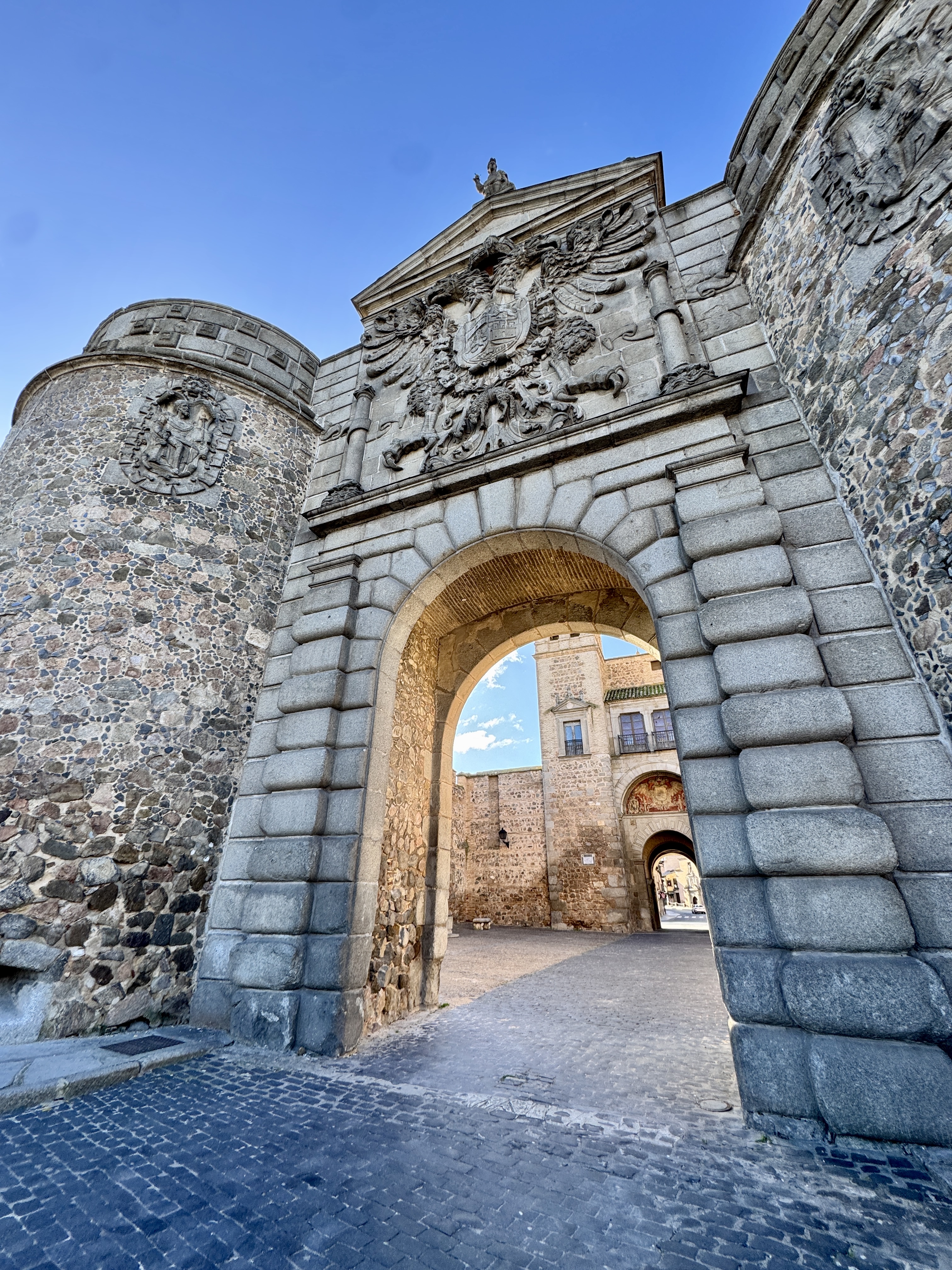 Narrow alleyway with colorful graffiti and hanging laundry in Malasaña district.