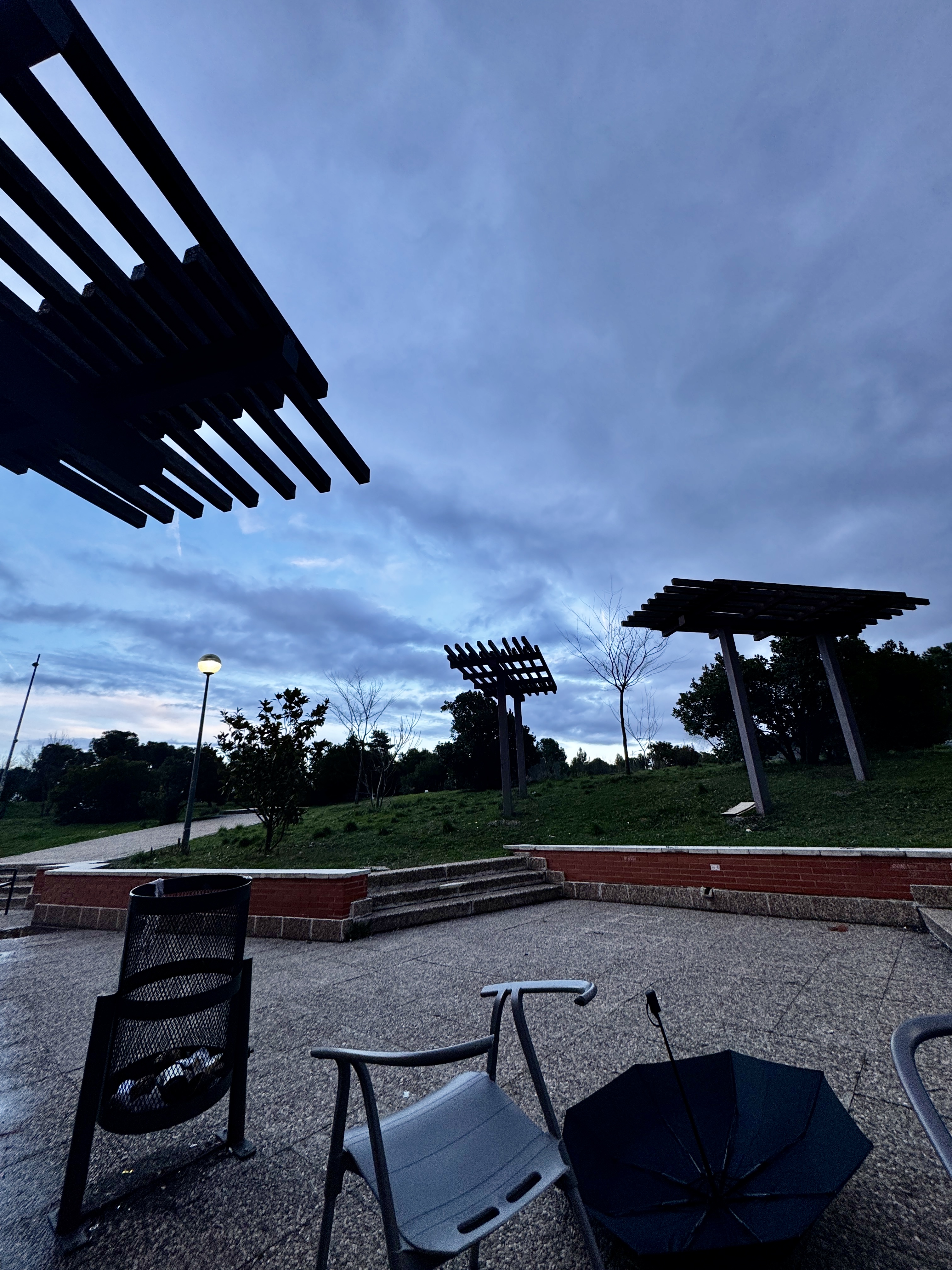 Urban textures of weathered stone walls and iron railings in central Madrid.