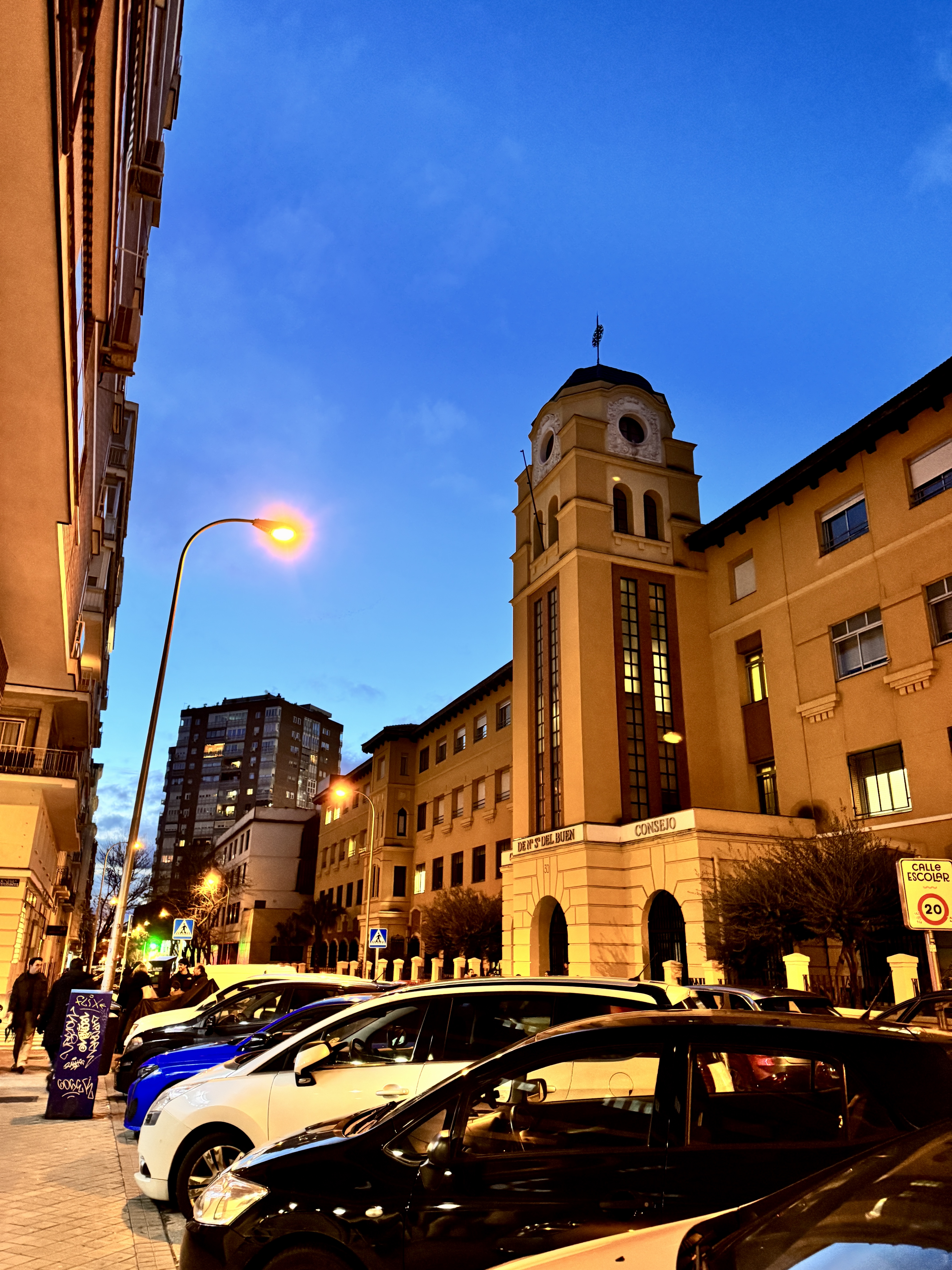 Empty plaza at dawn with historic buildings casting long shadows.
