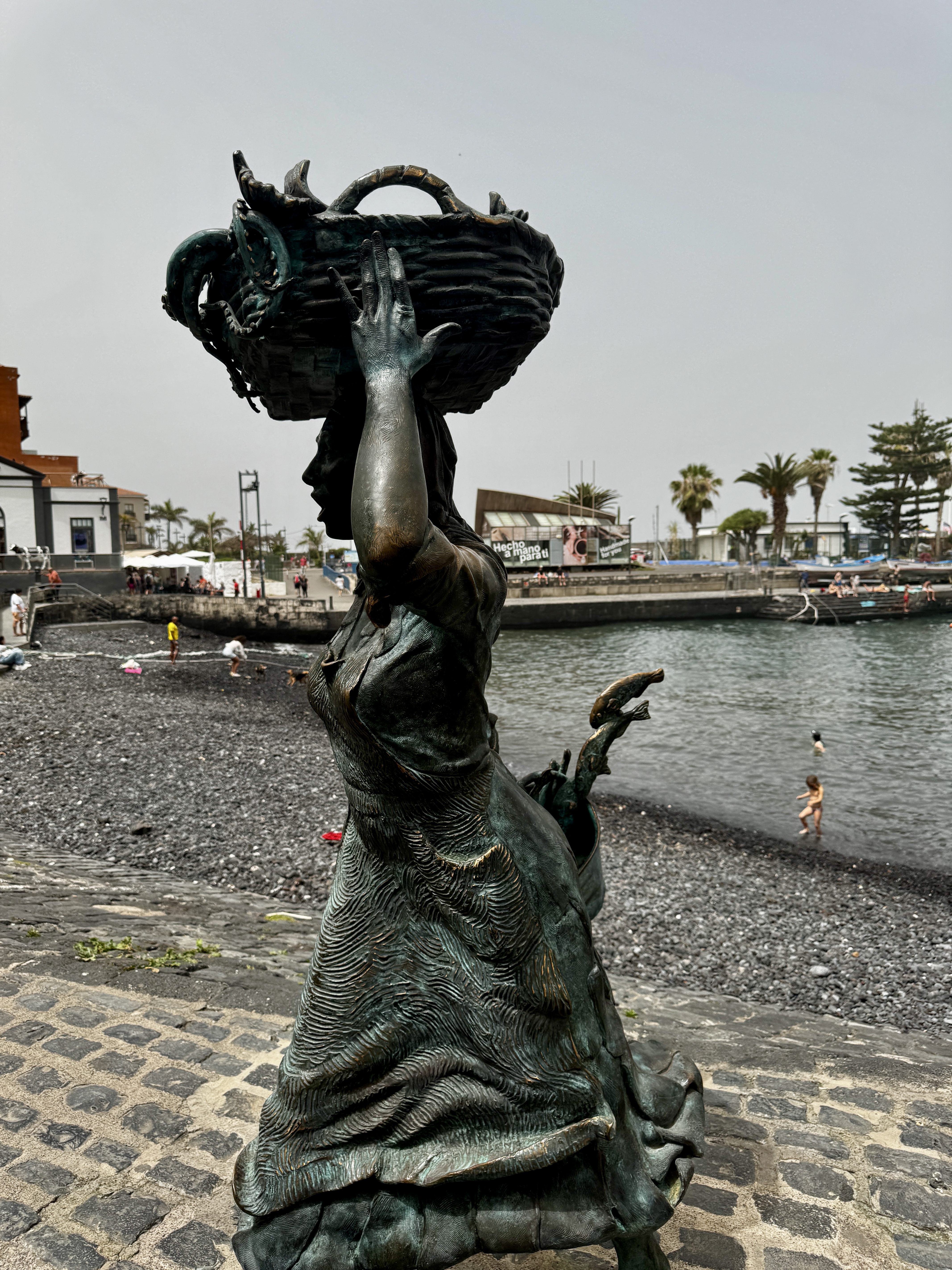 Coastal scene in Puerto de la Cruz, Tenerife with waves and volcanic textures.