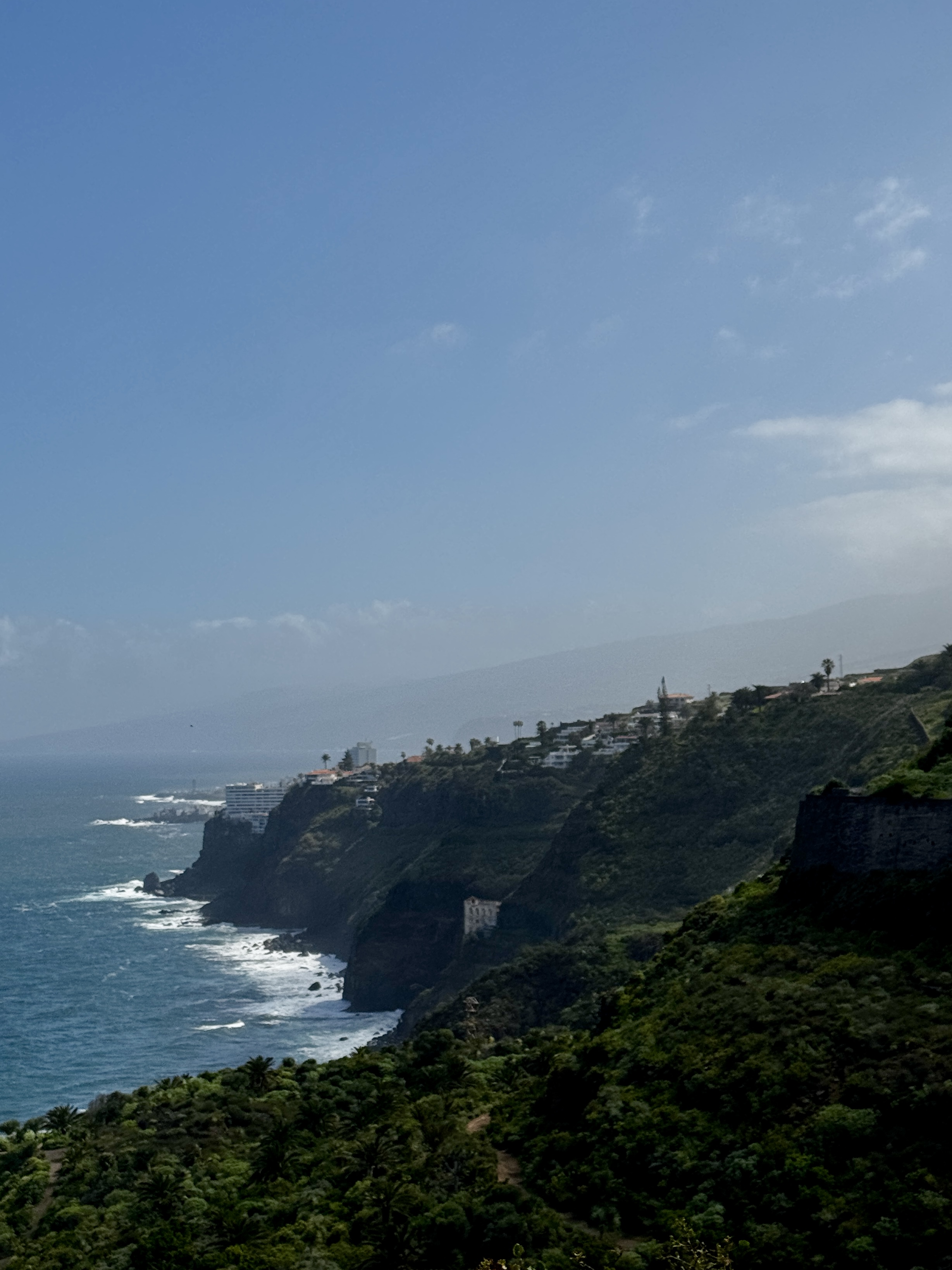 Atlantic cliffs in Tenerife at golden hour with ocean horizon beyond.