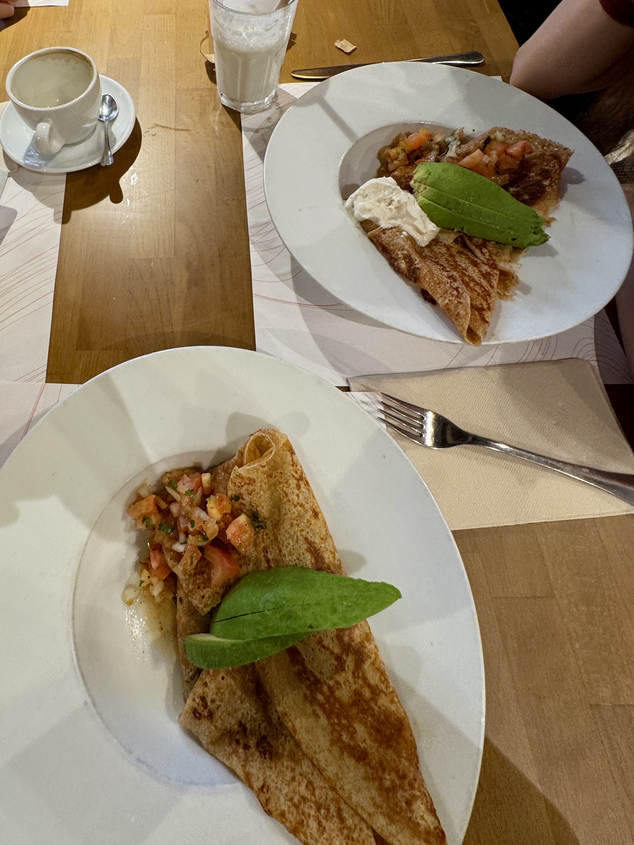 Boats on the lake with people rowing in the background.