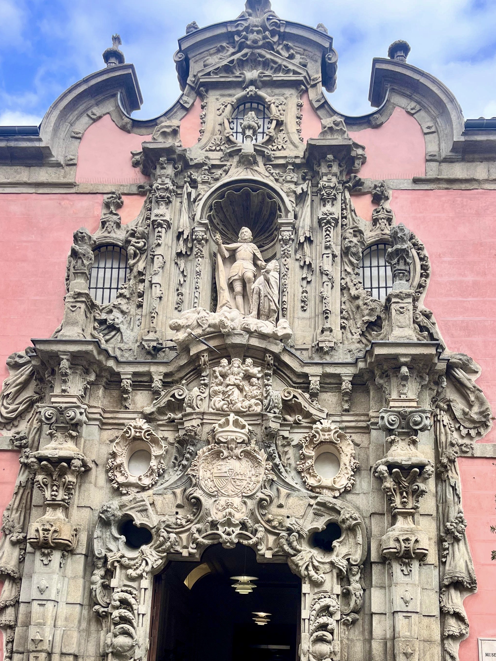 Illuminated fountains at night in a central plaza.